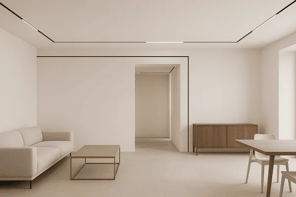 Minimalist modern living room with sleek lighting and neutral tones.